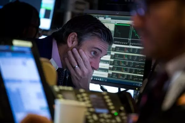 A trader looking at the charts on his computer.