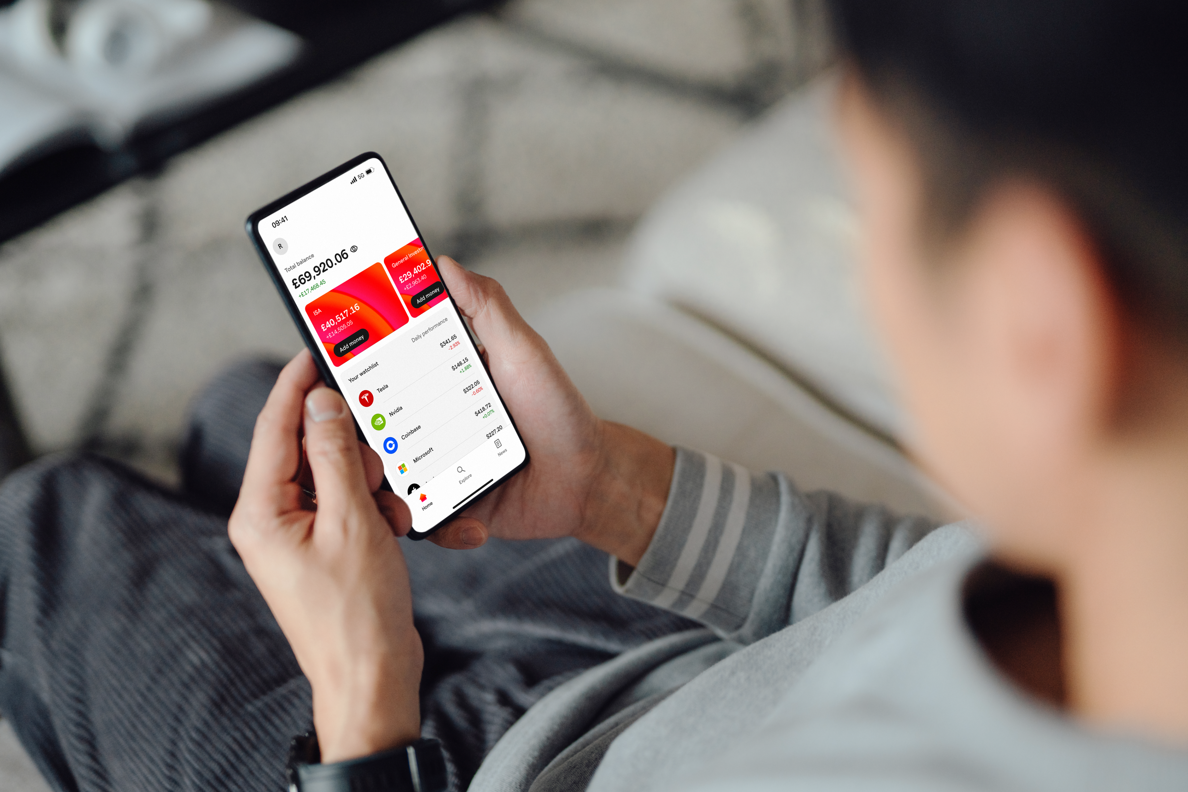 Person holding a mobile phone and looking at the IG App