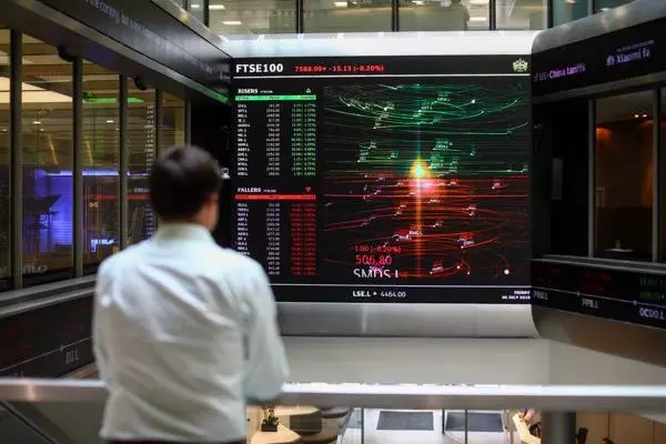 Image of trader in front of screens
