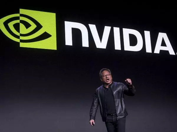 Nvidia CEO in front of logo